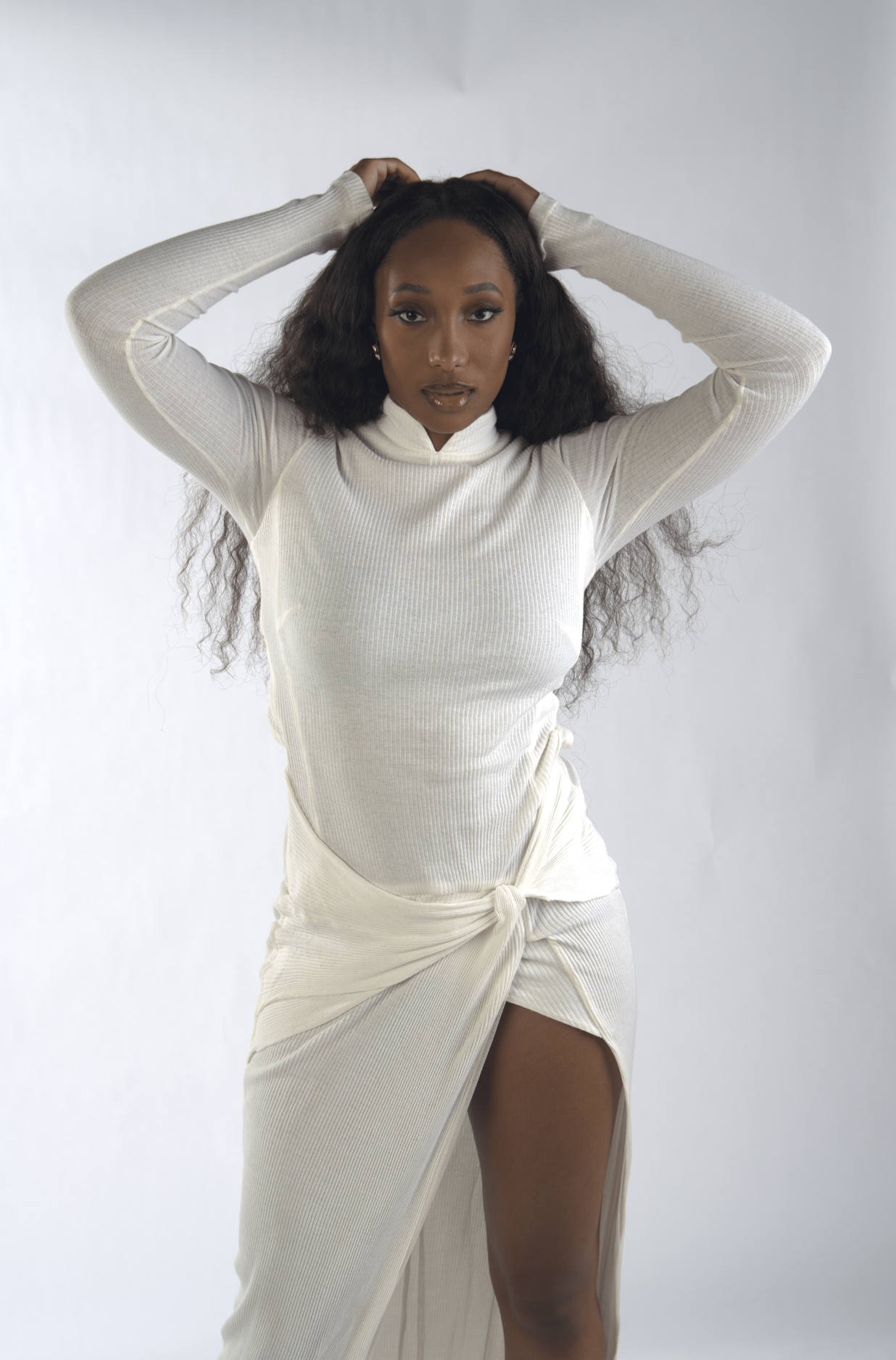Woman wearing a white outfit with a plain background